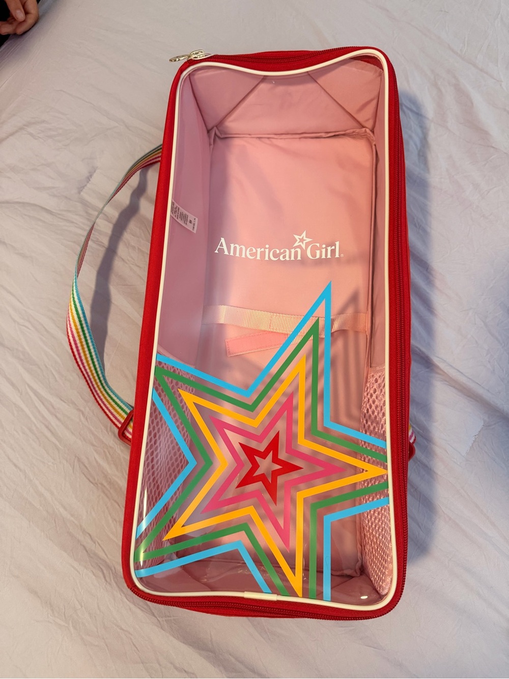 Never used-American Girl Pink and Red Clear Star Doll Carrier with Rainbow Strap